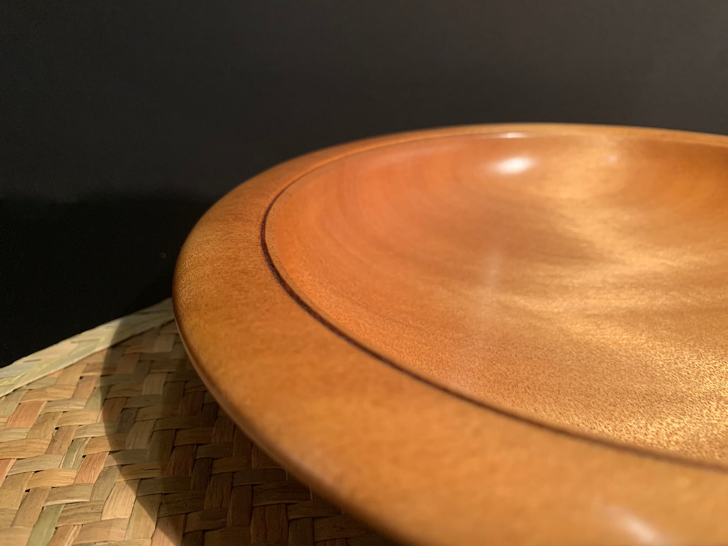 Wooden bowl rim with bevelled edge and subtle feature rim engraving.