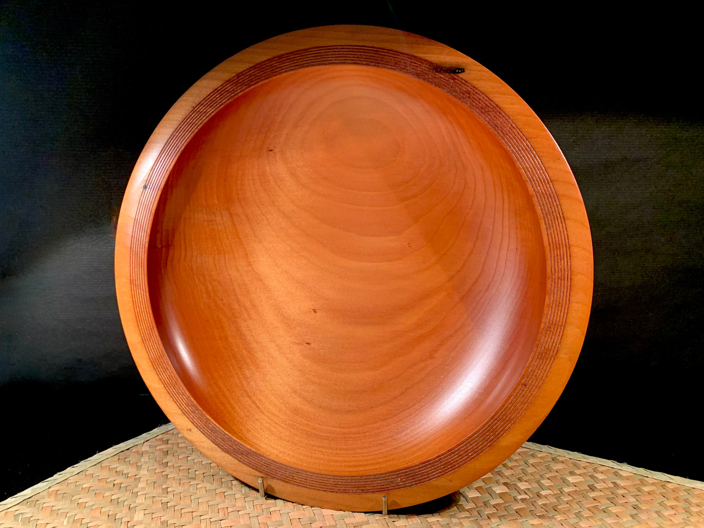 Wooden bowl with groove detailed rim and grain features.