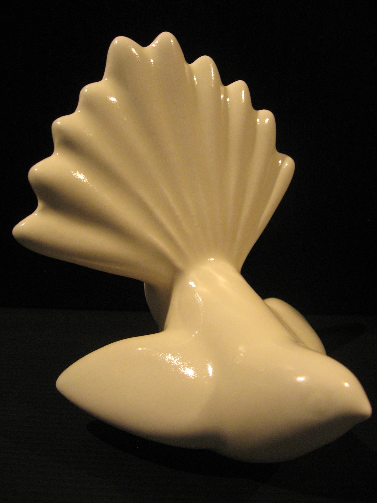 Side view of Ceramic Piwakawaka (Fantail) by Bob Steiner (white) Silver Fern Gallery