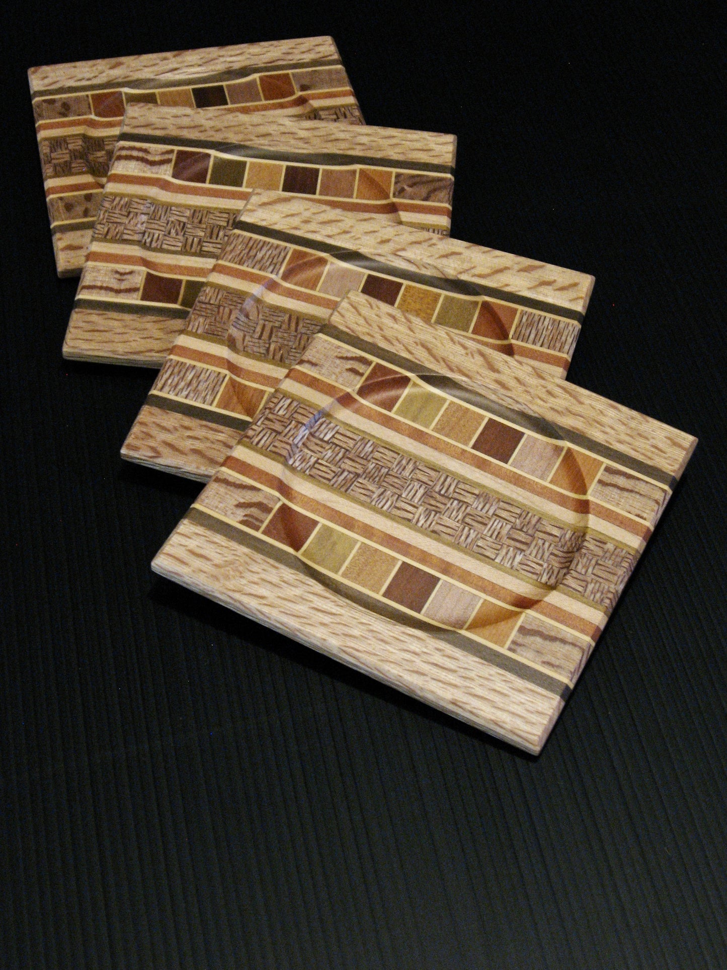 Set of Four Coasters showing many NZ Native Timbers with rewarewa wood border by Timber Arts Silver Fern Gallery