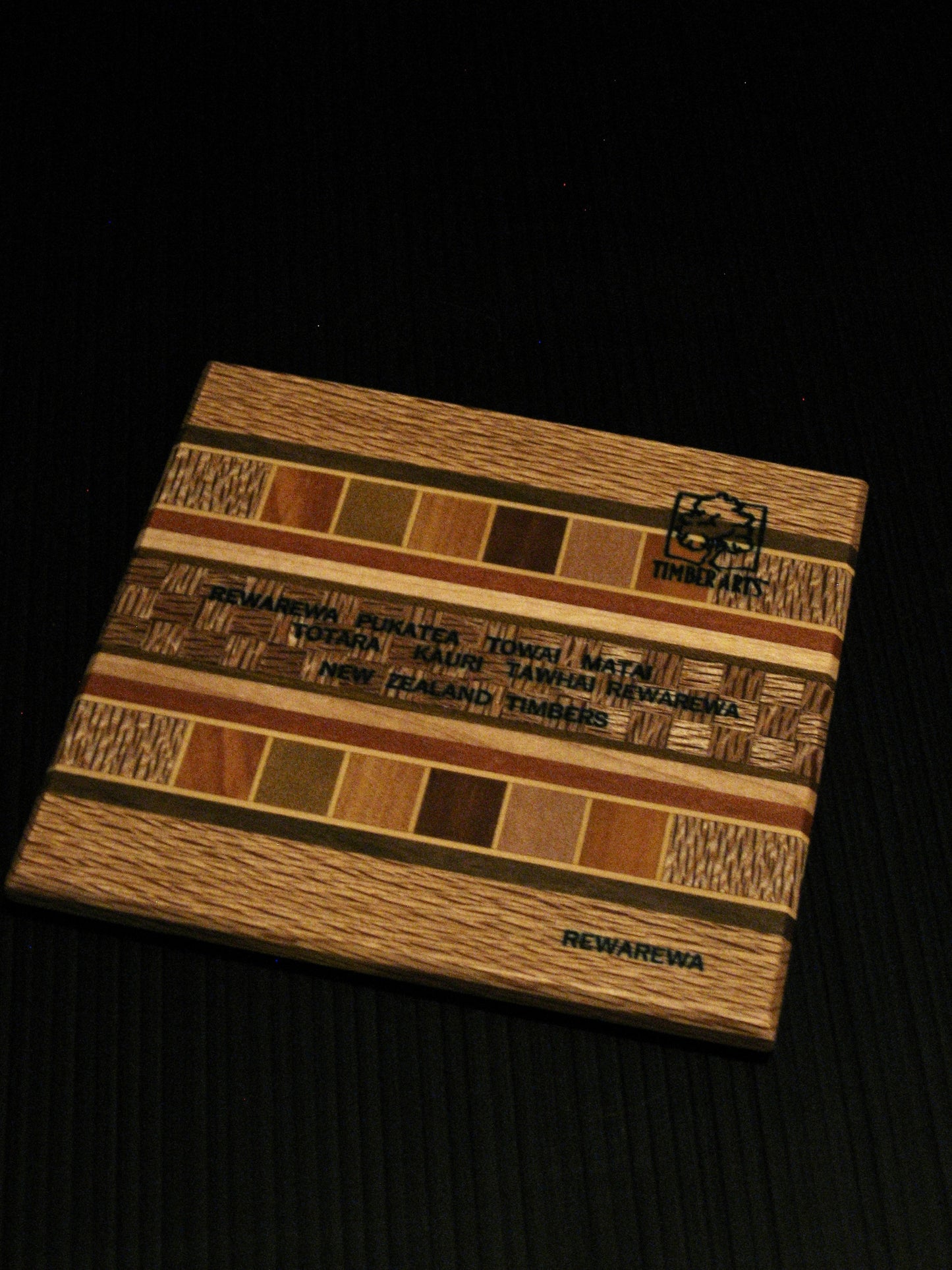 back of Coaster showing many NZ Native Timbers with rewarewa border by Timber Arts Silver Fern Gallery