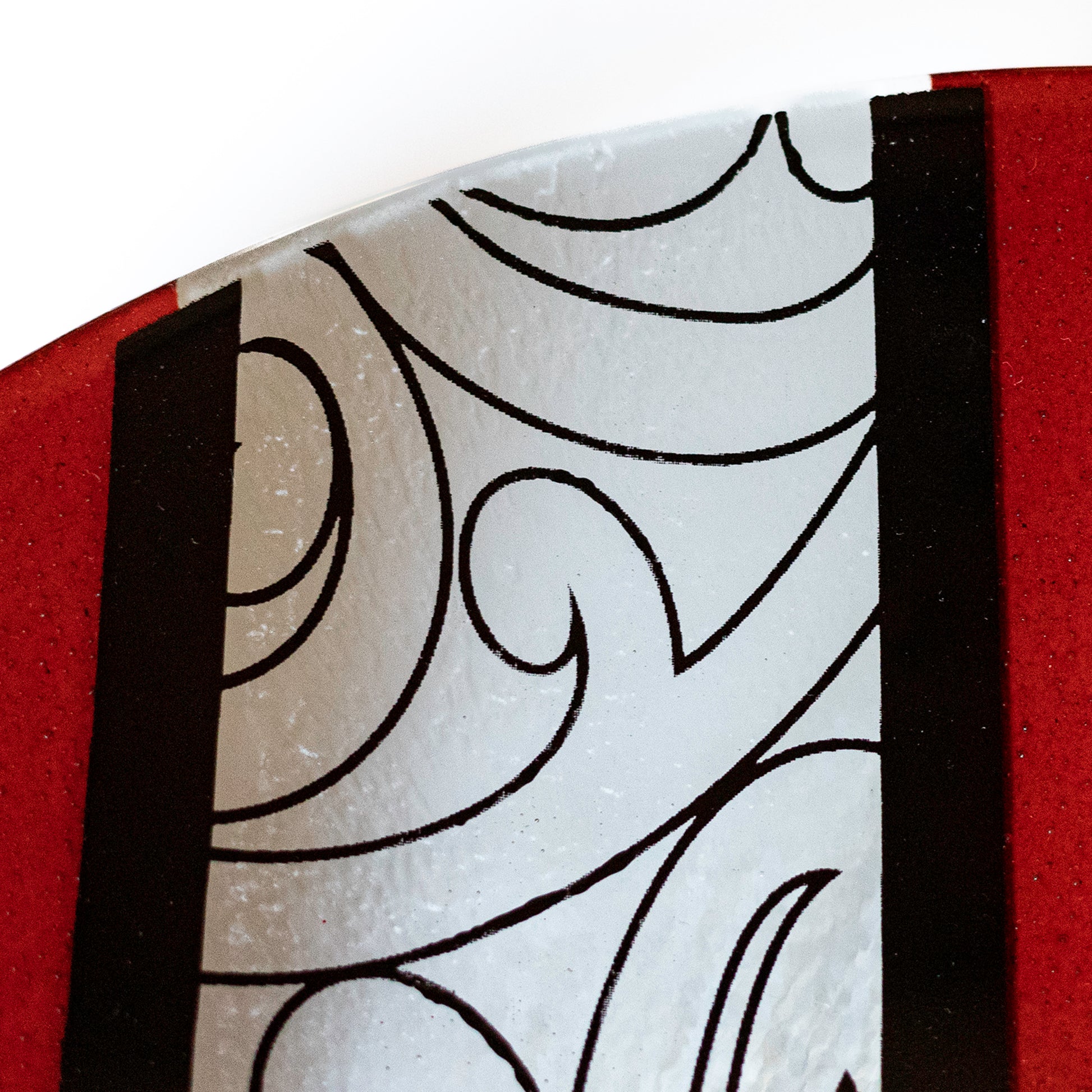 Detail of Fused Glass Bowl by Maori Boy Glassware Rongo Design (red and black) Silver Fern Gallery