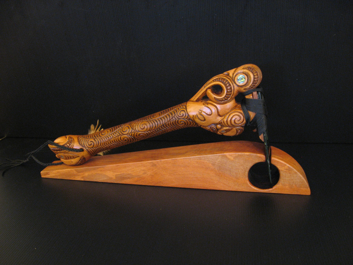 Side view of Hand Carved Toki Poutangata on Stand by Jason Holder Silver Fern Gallery