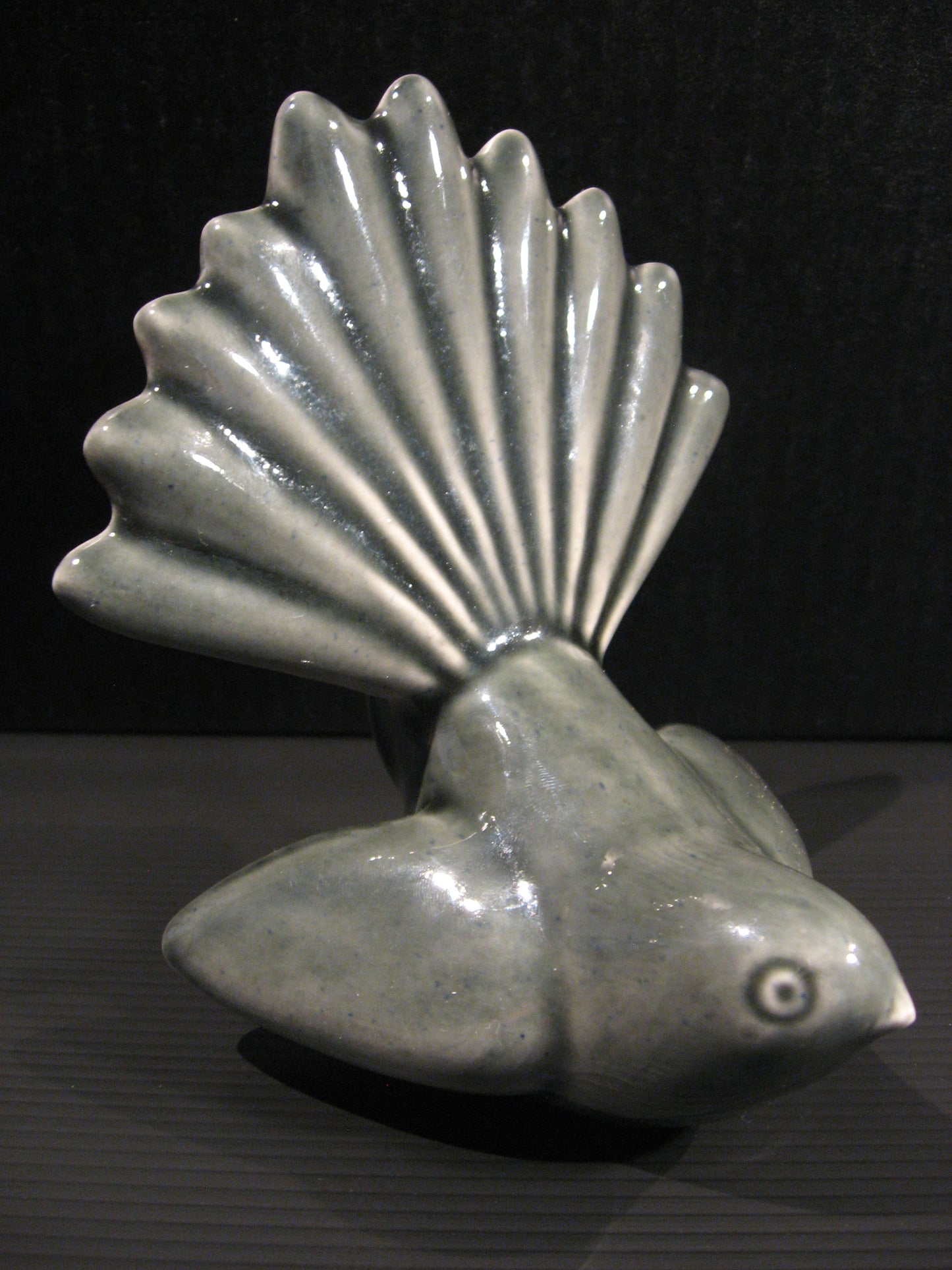 Side view of Ceramic Piwakawaka (Fantail) by Bob Steiner (black) Silver Fern Gallery